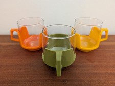 Retro vintage '60s '70s glass cups in plastic bases - green, orange, yellow