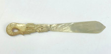 Mother of Pearl letter opener with decorative ornate carved handle - antique?