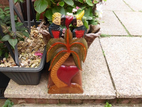 Hand carved colourful parrots - hand,