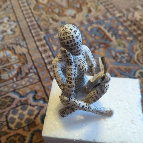 Figurine lady reading - of,