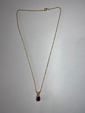 GOLD TONE CHAIN WITH A RED OVAL SHAPED GEM STONE PENDANT & CLEAR STONE ACCENT