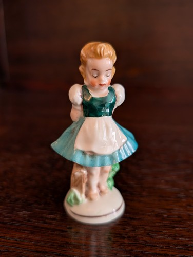 Small figurine girl in - a,