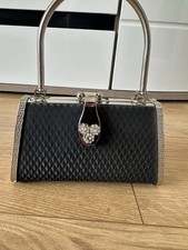 Women’s black and silver metal framed clasp bag