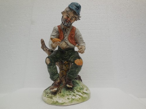 Tramp sitting tree stump - on,