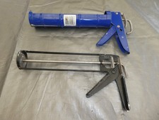 two sealant, adhesive guns  both working
