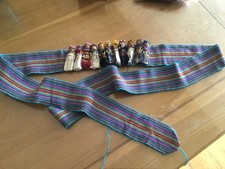 Vintage Guatemalan handmade worry dolls sewn to traditional weave belt