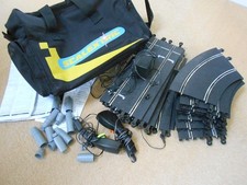 Scalextric Bag, scalextric track, 2 controllers, power plug, barriers. Untested.