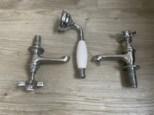 set of edwardian  bathroom taps and a handheld showerhead