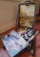 unusual french box easel, lots of oil paints, brushes and a palette.