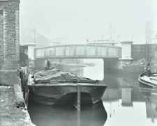 Man mooring a barge by a river