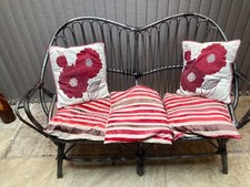 vintage wicker love seat resembling a franco albini love seat. 