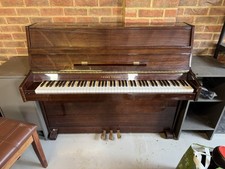 Young Chang upright piano, high gloss mahogany finish.  Piano stool included