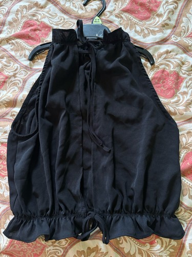 Black sleeveless top featuring - sleeveless,