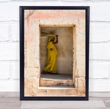 Woman yellow robe canes hole