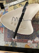 unusual Retro OGGI Corporation Boomerang Ashtray 60's on chrome stand with feet.