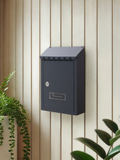 Grey post box - post, wall