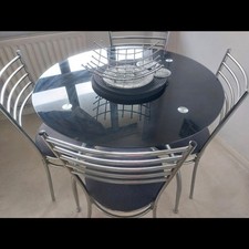 Stylish Glass Dining Table with 4 Chome and Black Padded Seating Chairs
