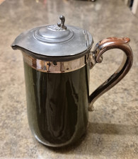 Antique jug with pewter lid and rim, fully glazed in green and brown and silver.