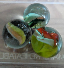 Three large vintage marbles five and four vane.
