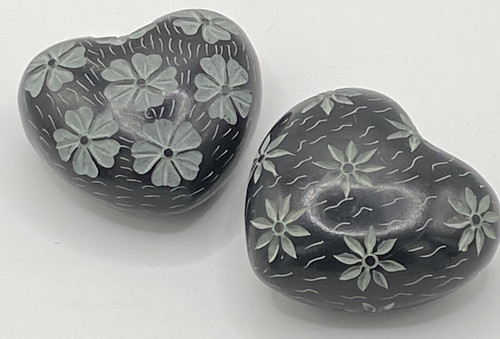 Black stone heart hand - hand, carved