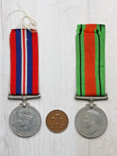 A pair of British WW2 medals, 1939-45 Defence Medal and War Medal with ribbons