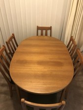 McIntosh Extendable Dining Table In Teak for Sale Accompanied by Six Chairs.