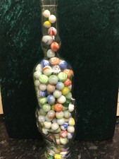 MARBLES A HAND  BOTTLE OF MARBLES