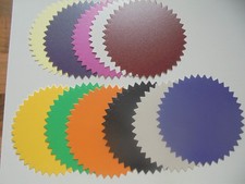 25 X ALL DIFFERENT COLOURED CARD DIE CUT ROUND SPIKED SHAPES.  SPIRELLI/TOPPERS