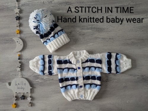 Babies hand knitted jacket and - hand,