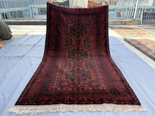 Brown hand knotted afghan - hand,