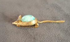 vintage gold-tone mouse brooch with a turquoise-colored cabochon stone