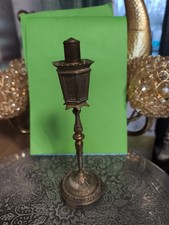 An antique brass table lighter
