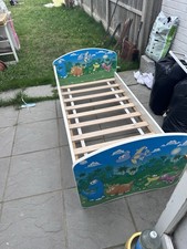 Dinosaur toddler bed with Mattress and removable safety board.