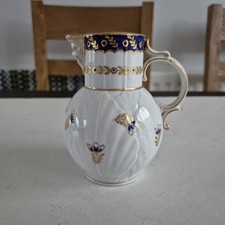 An Early Derby? Porcelain Mask Jug Footrim Chip