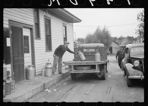 Unloading milk cans - , at