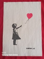 Banksy painting and drawing on