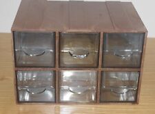 Bank of six small pull-out drawer units.