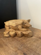 Handcarved pig in a lying down postion from a farming estate in brecon