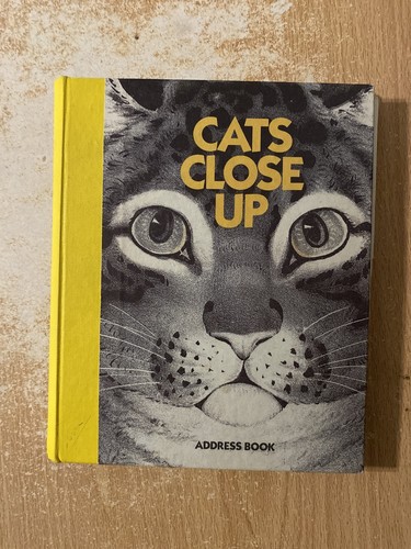 Cats close address book - up,