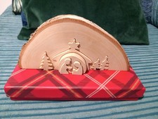 Nativity scene cut from slice of wood.