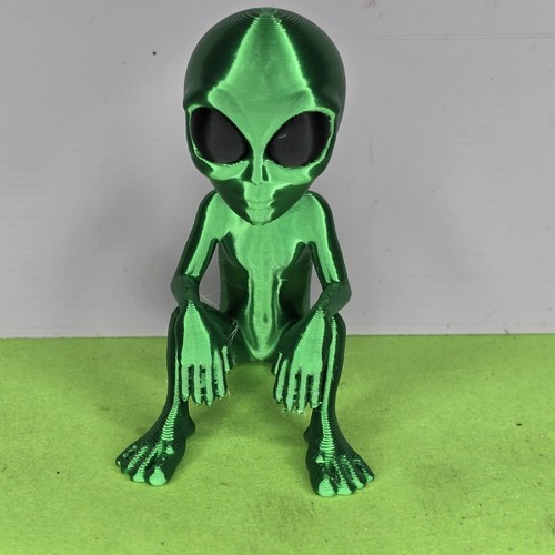 Little green alien sitting - green,