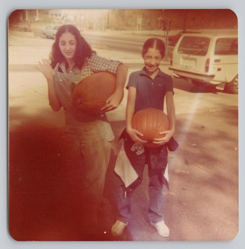 1980s girls holding pumpkins - holding,