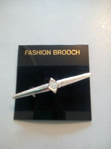 Silver colour brooch with - colour,