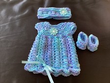 Hand knitted dolls clothes to