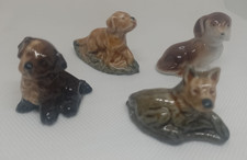 Four Collectable dog figurines, Wade Whimsies plus one other, VGC 
