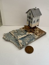 House/hut on stilts on the beach on a piece of driftwood. Handmade. . Wood.