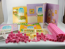 Vintage Sindy doll cardboard house panels + pink plastic frame pieces.
