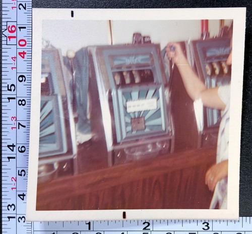 Man operating old slot machine - old,
