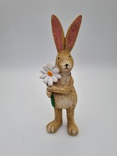 Jasper Rabbit Holding A Daisy