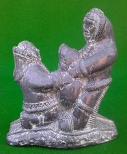 A WOLF ORIGINAL TWO INUIT / ESKIMO FIGURES WITH SEAL.